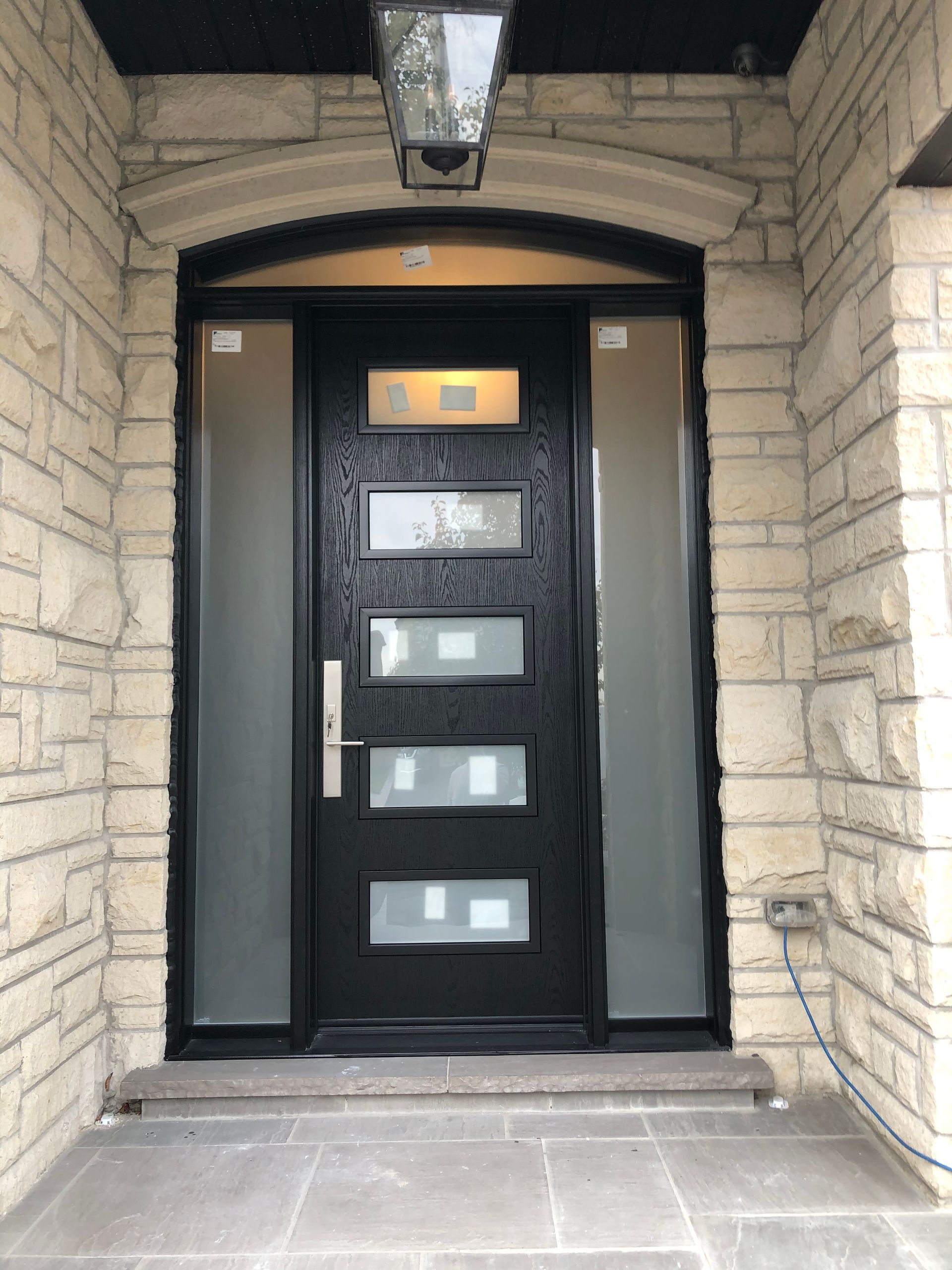 The front door of a brick building with a black door