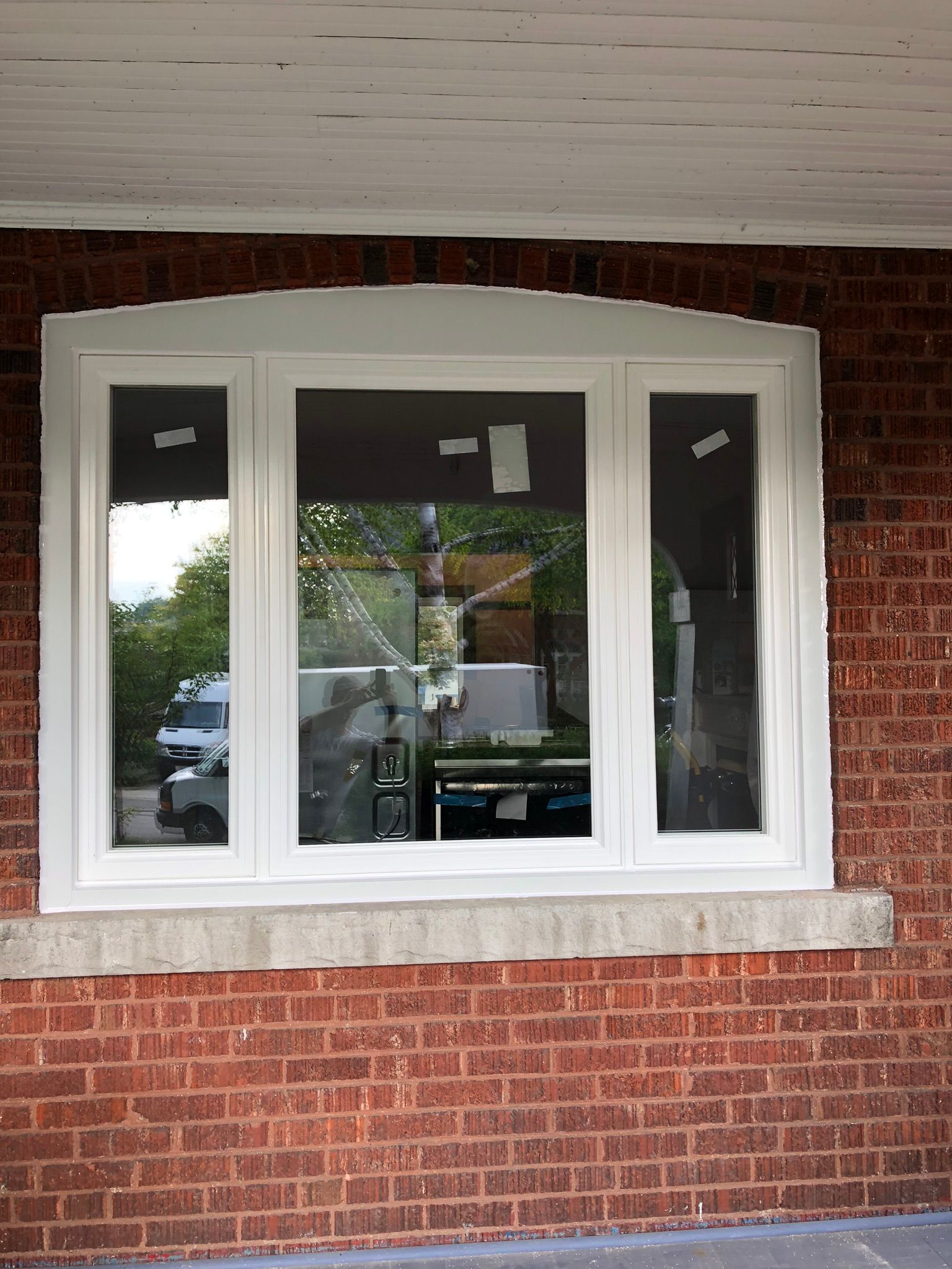 A brick wall with a white window on it