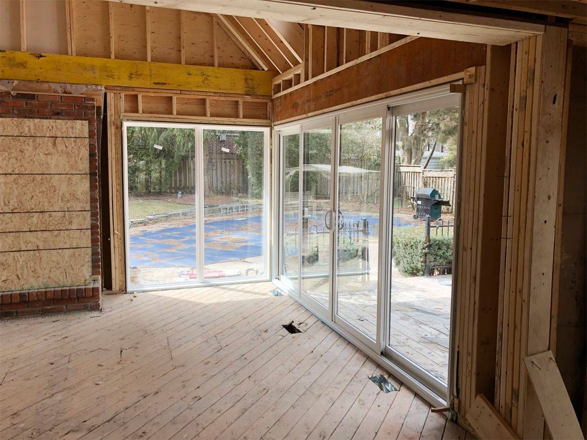 A room in a house under construction with sliding glass doors.