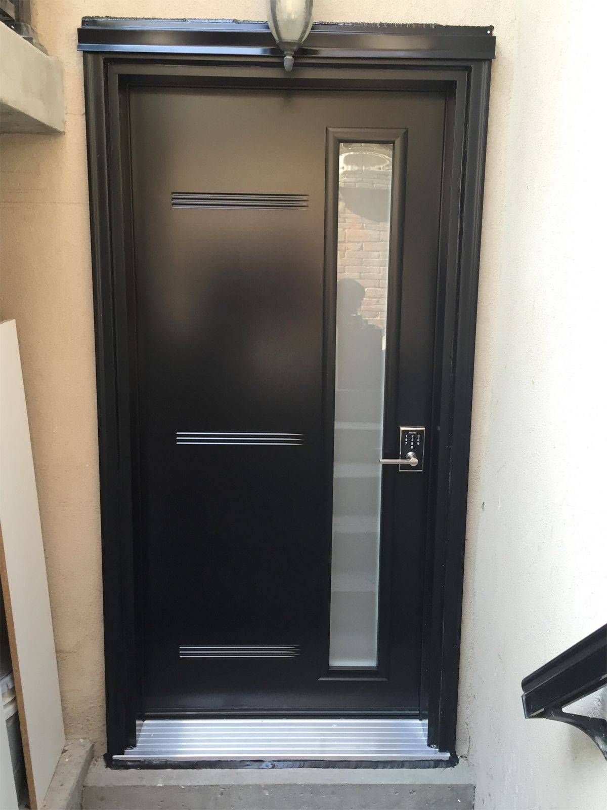 A black door with a glass window on the side of it.