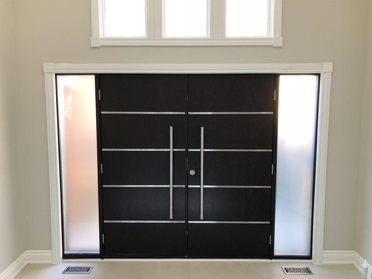 A black door with a stainless steel handle