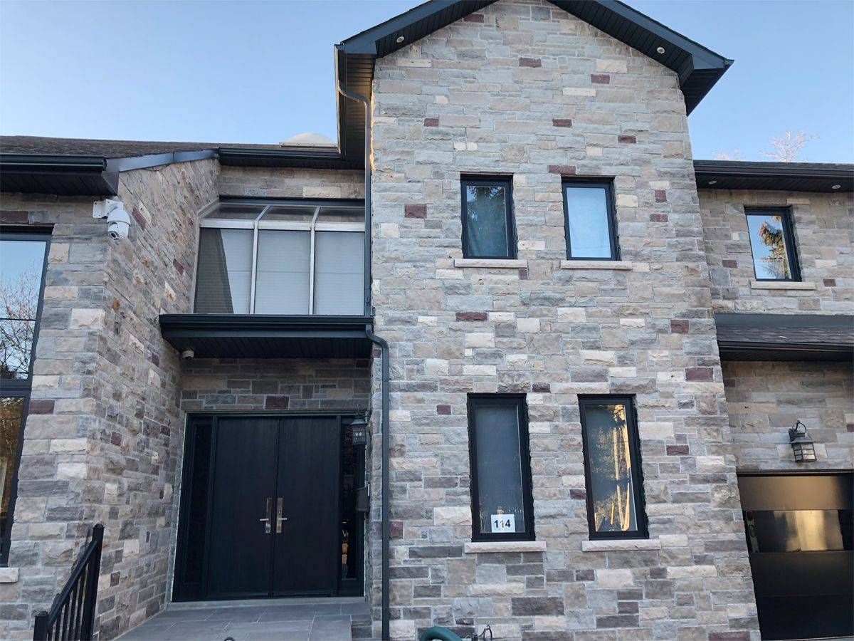 A large brick house with a black door and windows