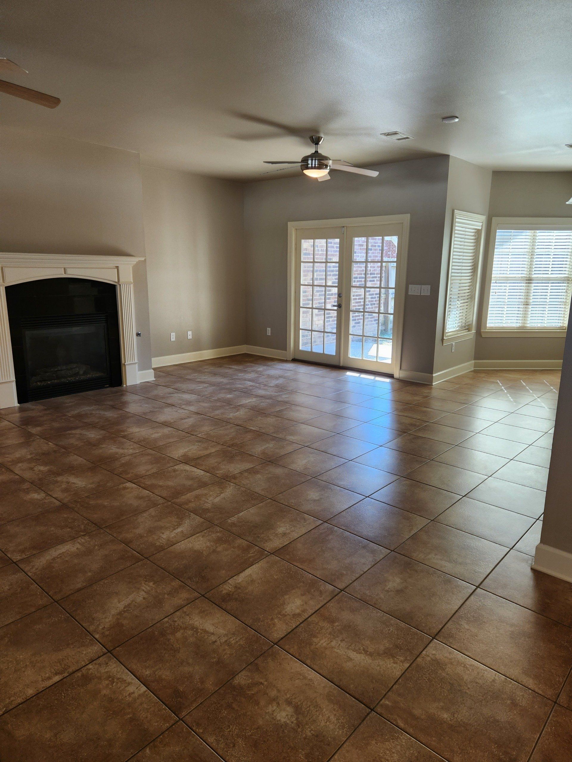 Living room with fireplace and ceiling fan