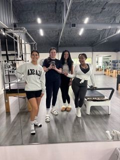 New client  in her first BE Pilates class receiving personalized instruction in Burleson, Fort Worth