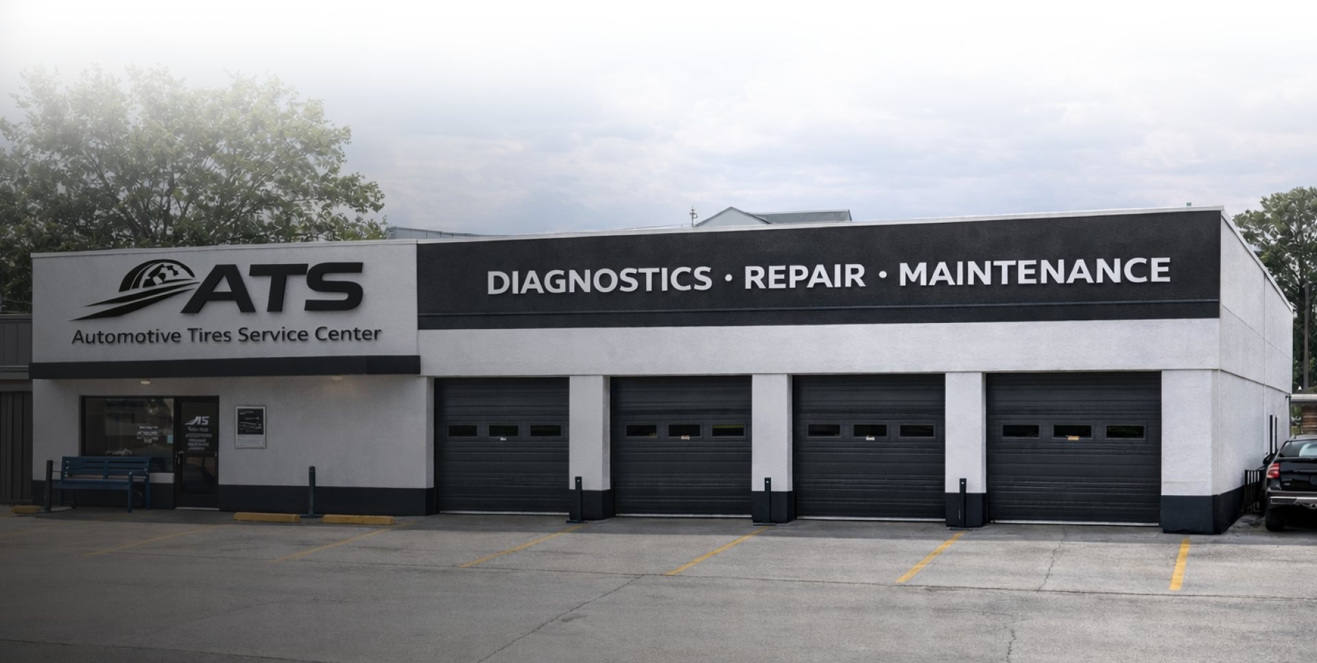 A row of three classic cars parked in front of a building with a 