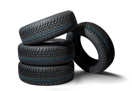 A stack of three black tires with thin blue and yellow stripes along the tread, with one tire leaning against them.