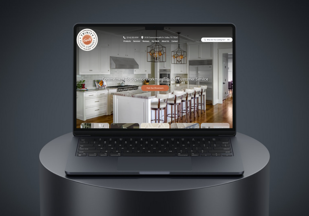 Hand holding a phone displaying the Google Ads logo against a blurred background of a computer screen with charts.