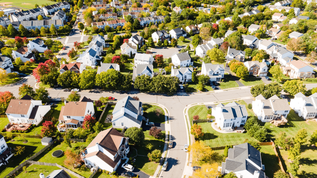 An aerial view of a residential neighborhood with lots of houses and trees.