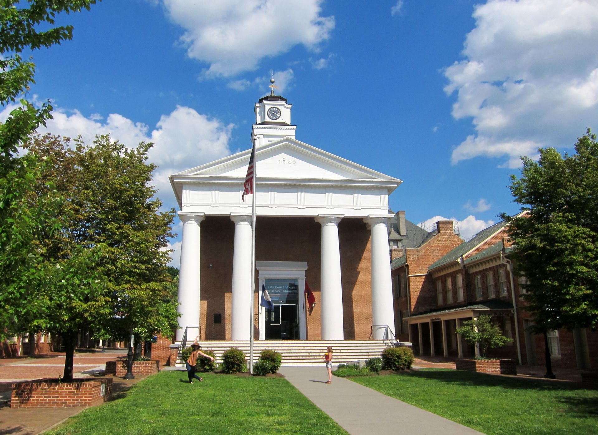 A large building with columns and a clock tower