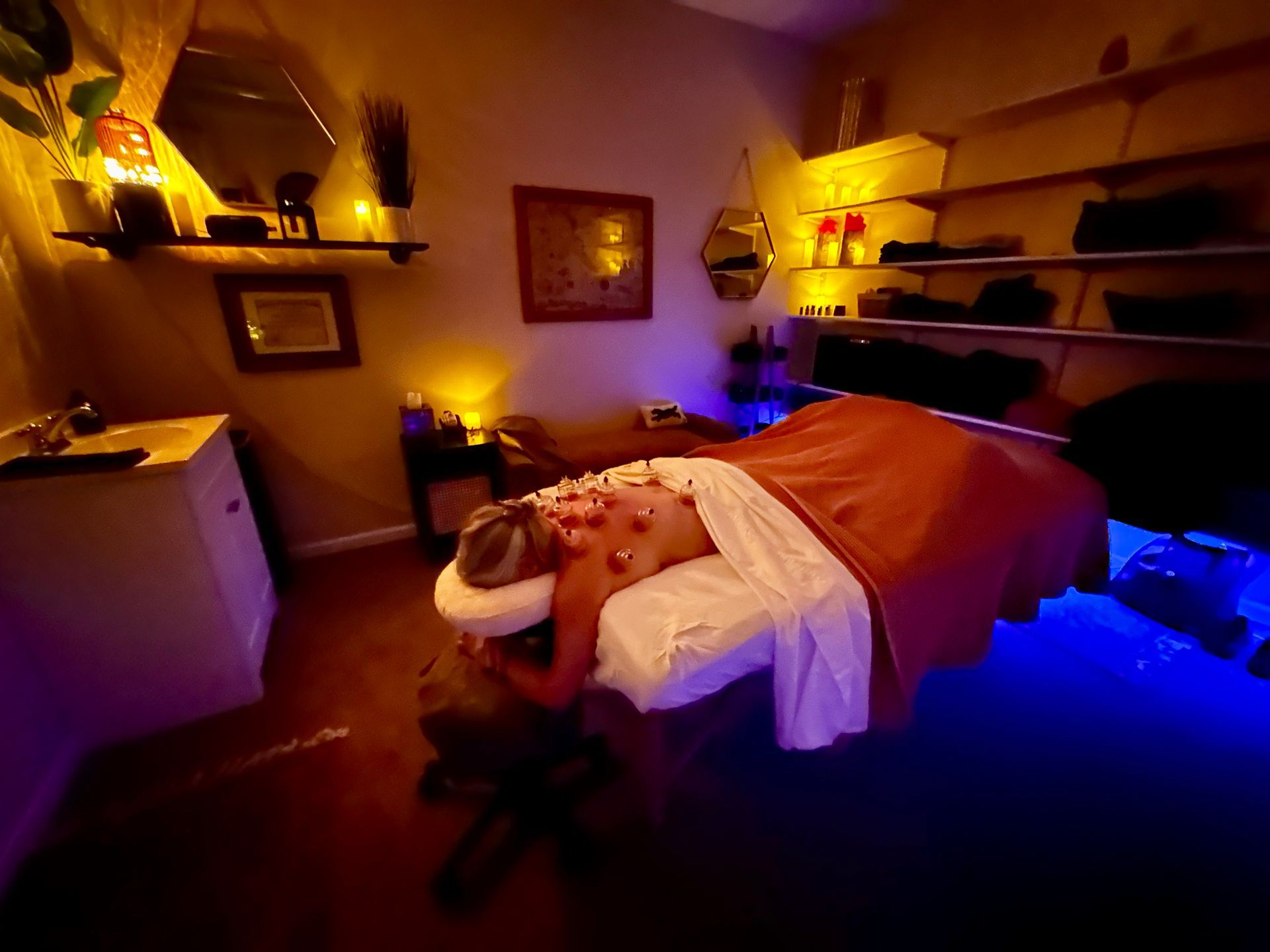 A person receives a neck massage from a massage therapist in a spa setting.