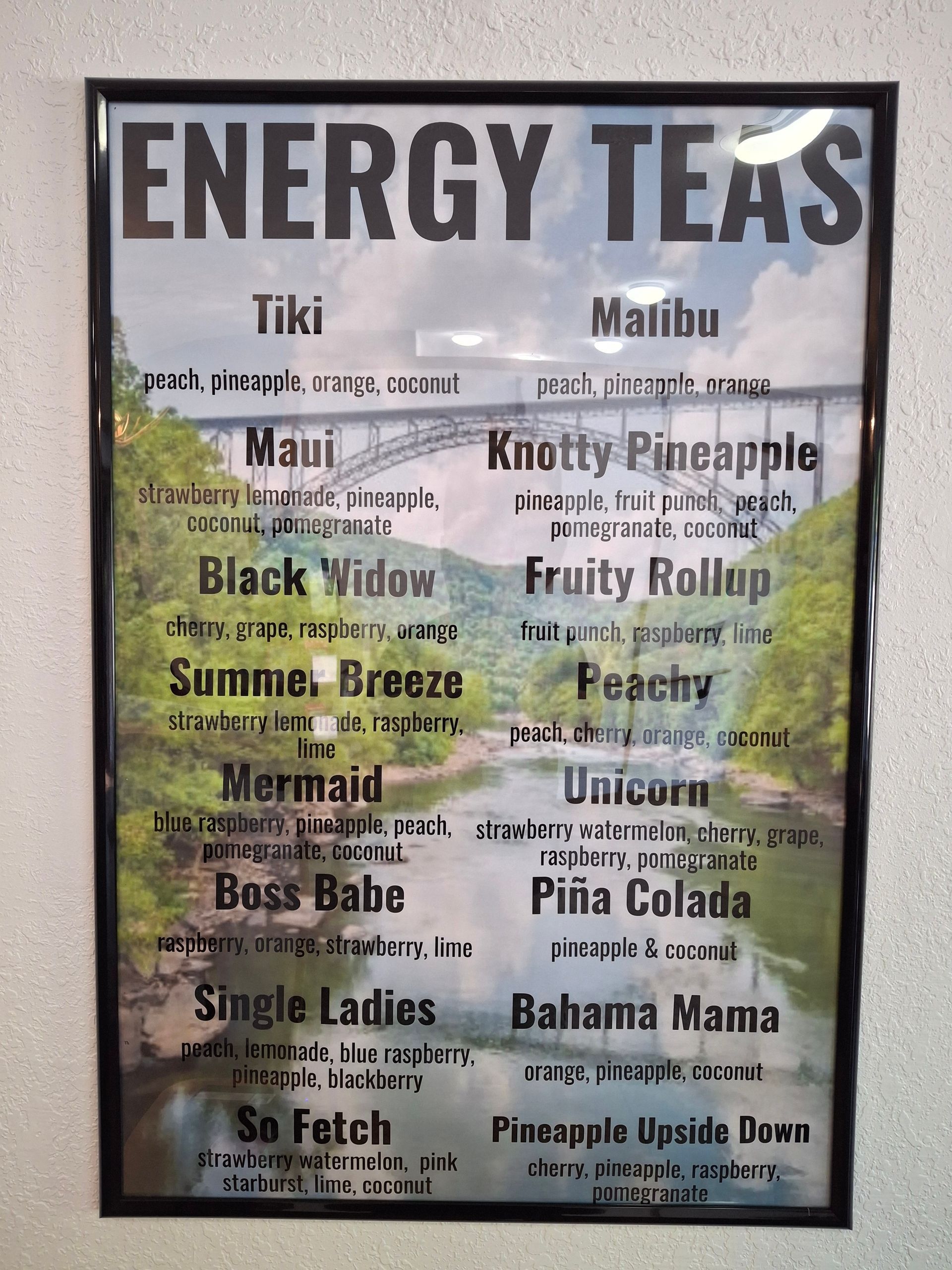 A framed poster with a list of energy teas