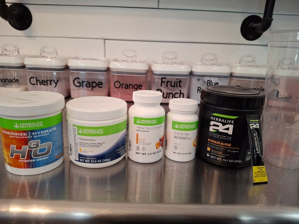 A scoop of protein powder is sitting on top of a pile of protein powder.