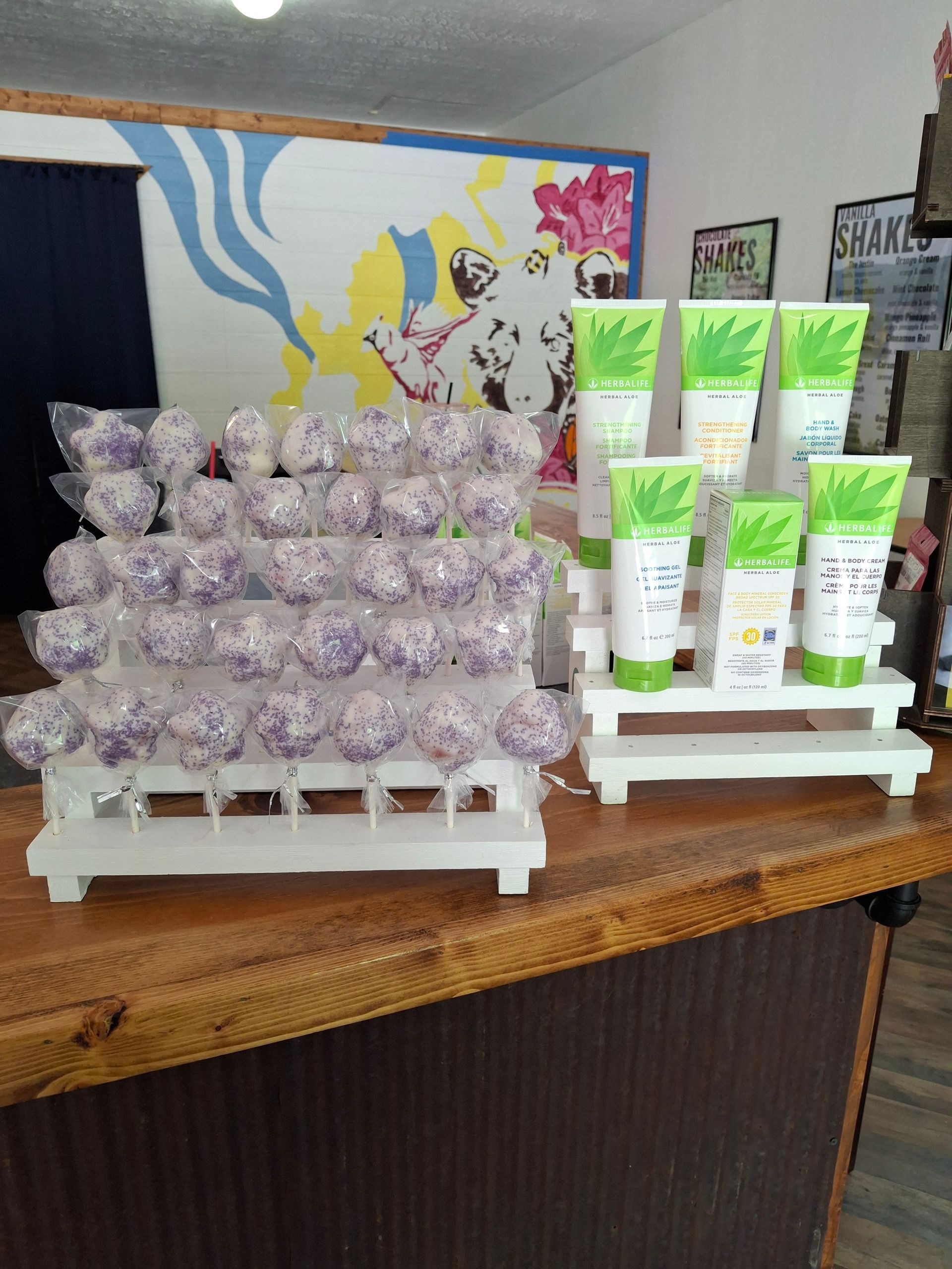 A woman is laying in bed with her hands on her wrist.