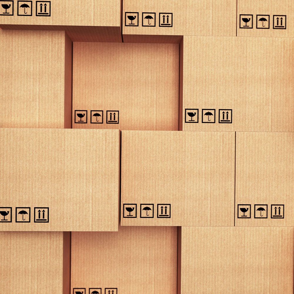 A stack of cardboard boxes with fragile signs on them