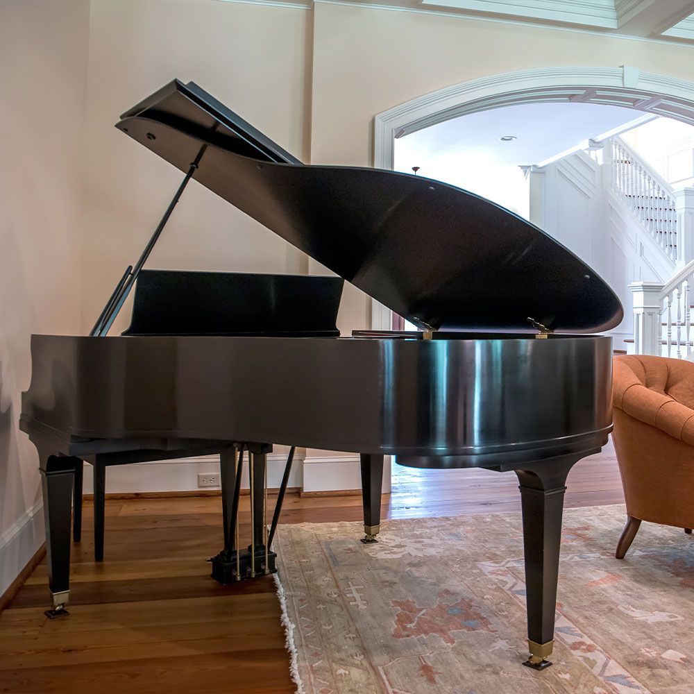 A piano in a living room with the lid open