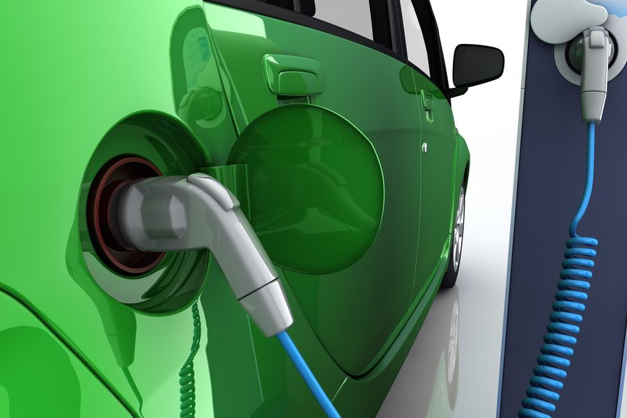 Up close view of green electric vehicle being charged