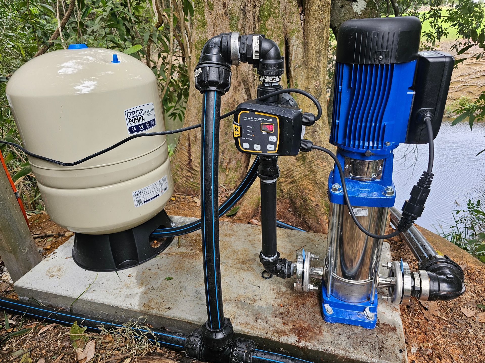 A Man Is Installing Water Pumps On Pool — Jobec Pumps & Irrigation In Murwillumbah, NSW
