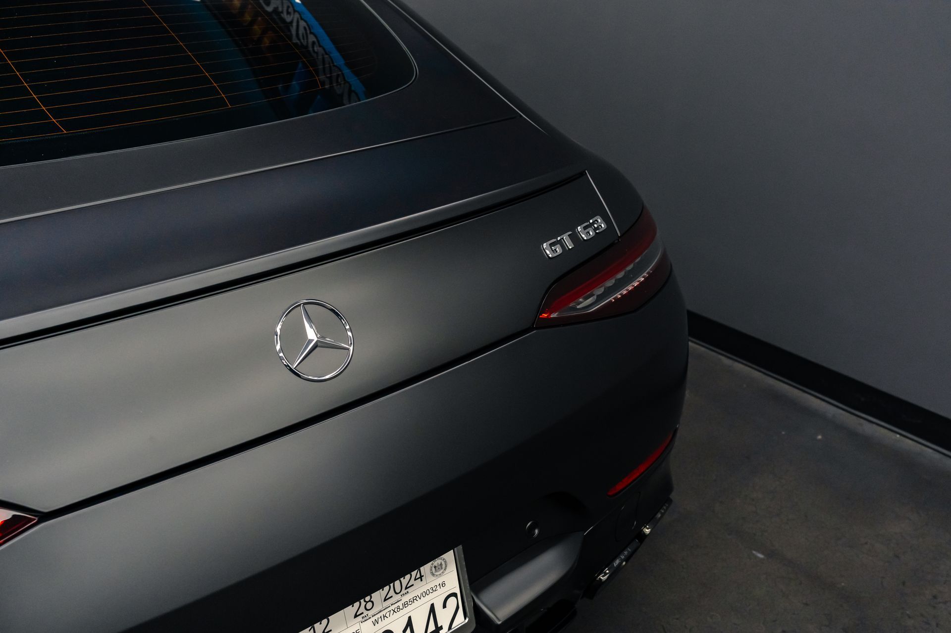 The back of a black mercedes benz gt63 is shown.