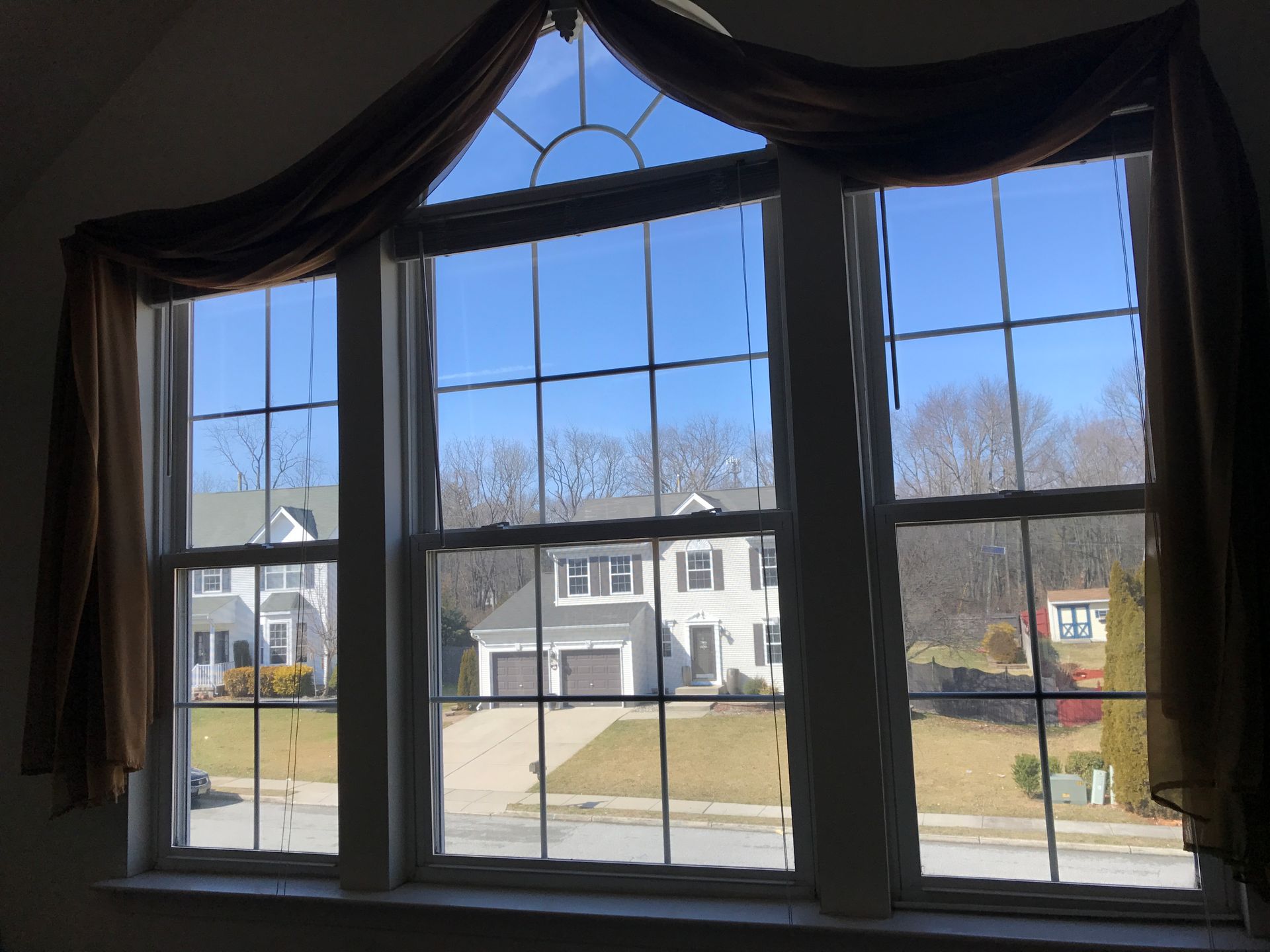 A window with a view of a house in the background