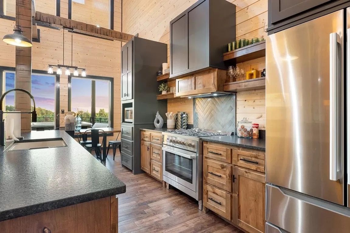 A kitchen with stainless steel appliances and wooden cabinets.