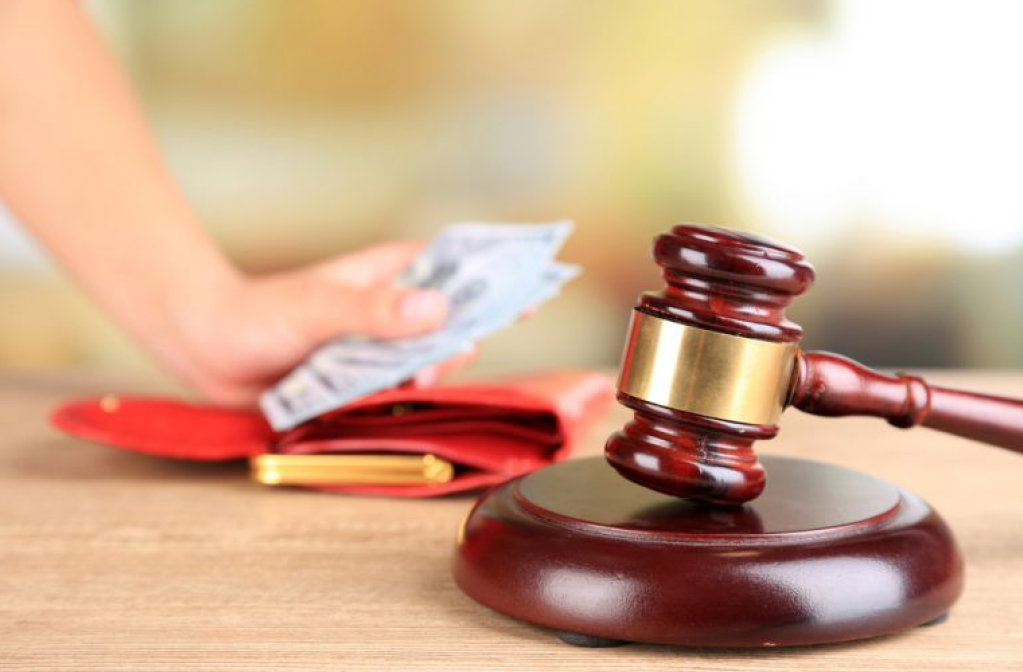 Gavel Next to a Person Holding Money — Florissant, MO — Teague & Associates, LLC