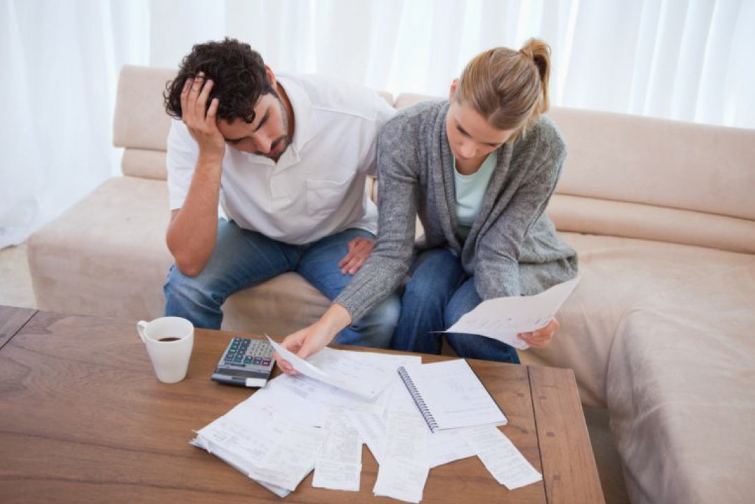 Two People Looking at Their Bills — Florissant, MO — Teague & Associates, LLC