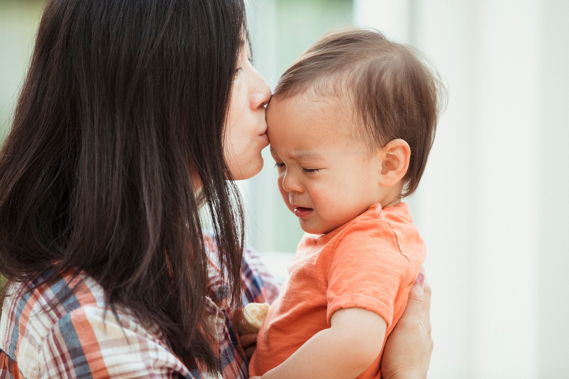 A mother comforting her child before a pediatric dental visit. A mother comforting her child before a pediatric dental visit.