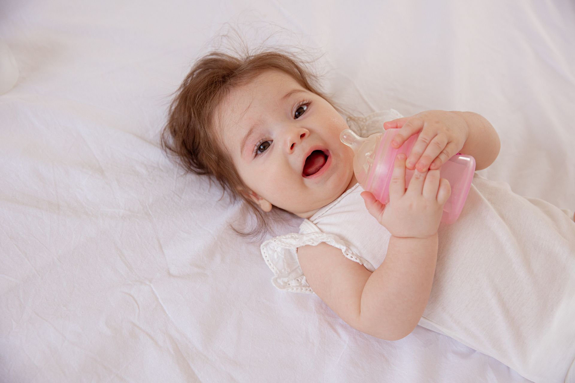 Baby with bottle during early dental care education. Baby with bottle during early dental care education.