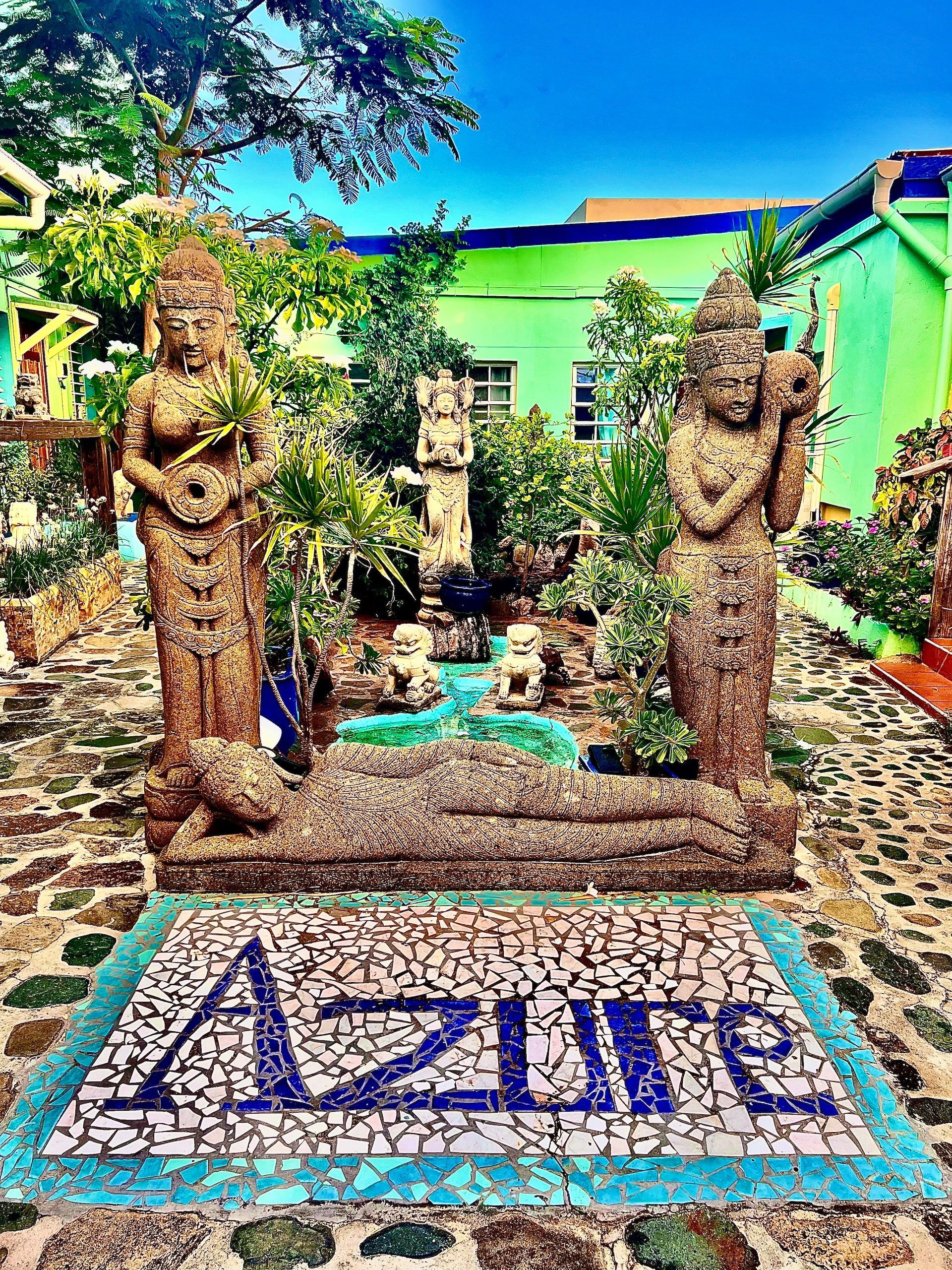 Statues and mosaic sign for 