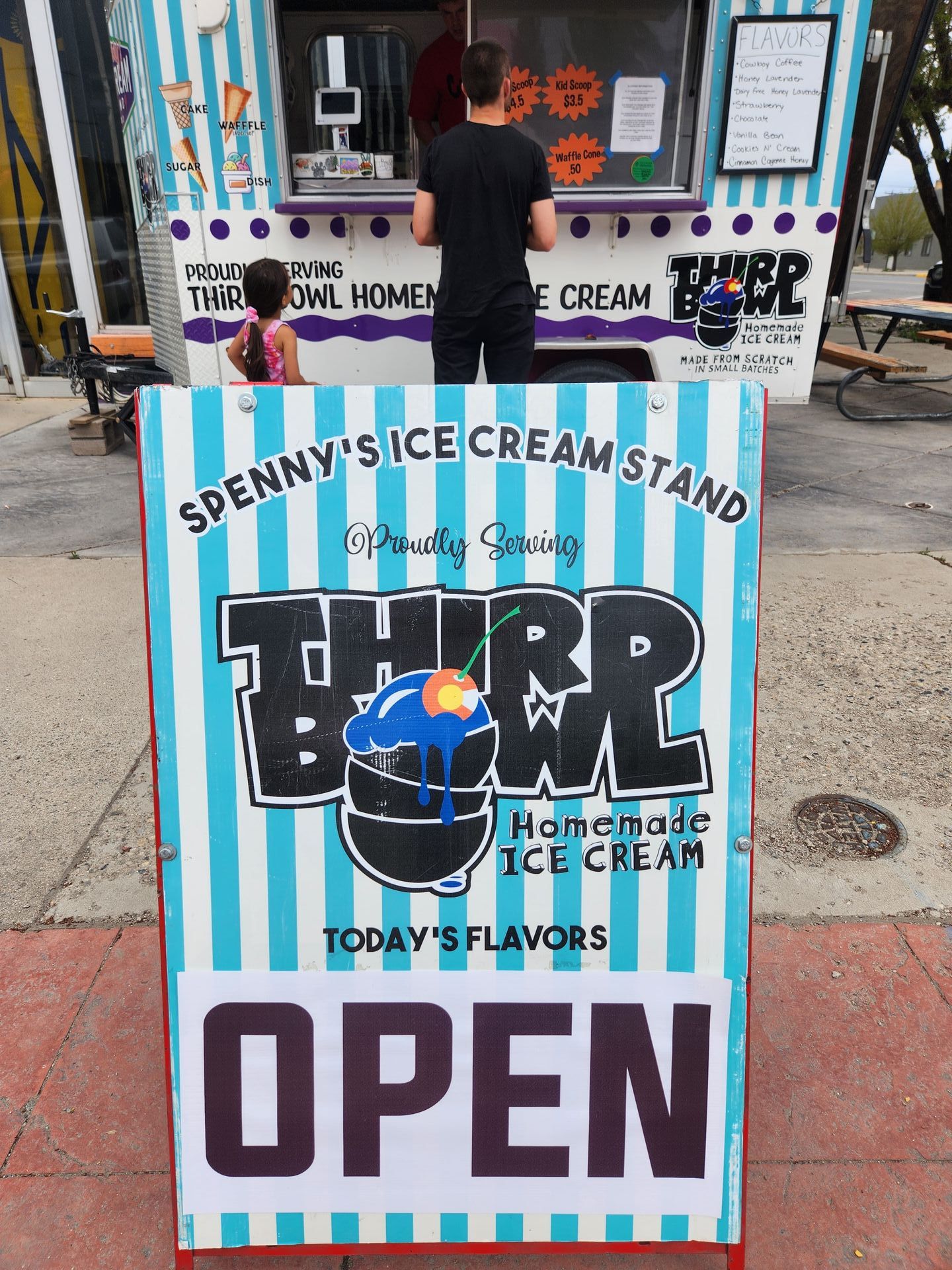 A sign for penny 's ice cream stand says it is open