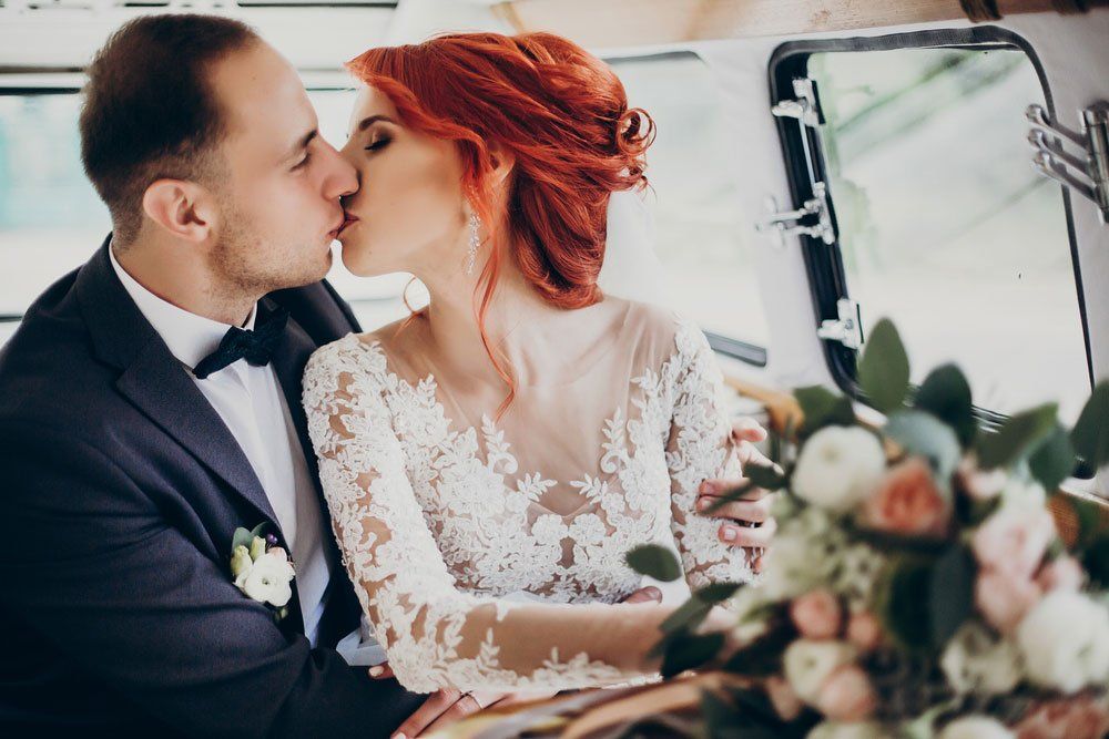 Bride and groom kissing in limousine — Limousine Hire in Central Coast, NSW
