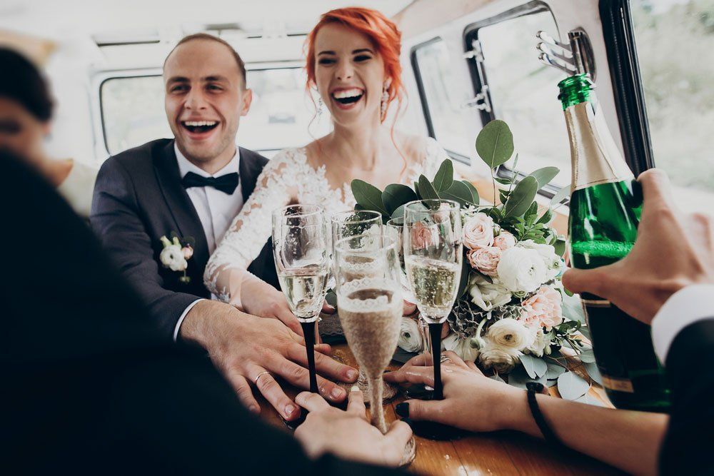 Bride and groom drinking in limousine — Limousine Hire in Newcastle, NSW