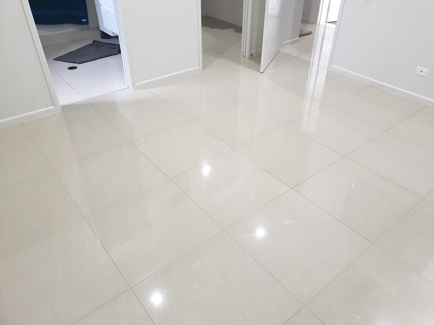 Empty Room With Glossy, Light-coloured Tiled Floor — Tropic Tiling in Tolga, QLD