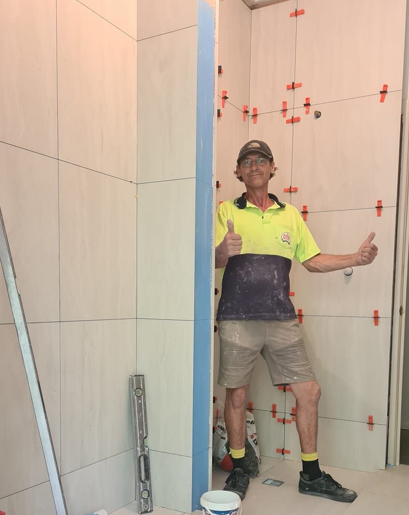 A Man in a Construction Site Gives Thumbs Up — Tropic Tiling in Tolga, QLD