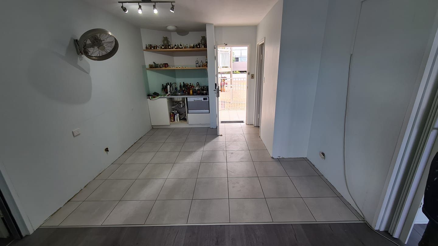 Empty Room With Gray Tiled Floor, White Walls — Tropic Tiling in Tolga, QLD