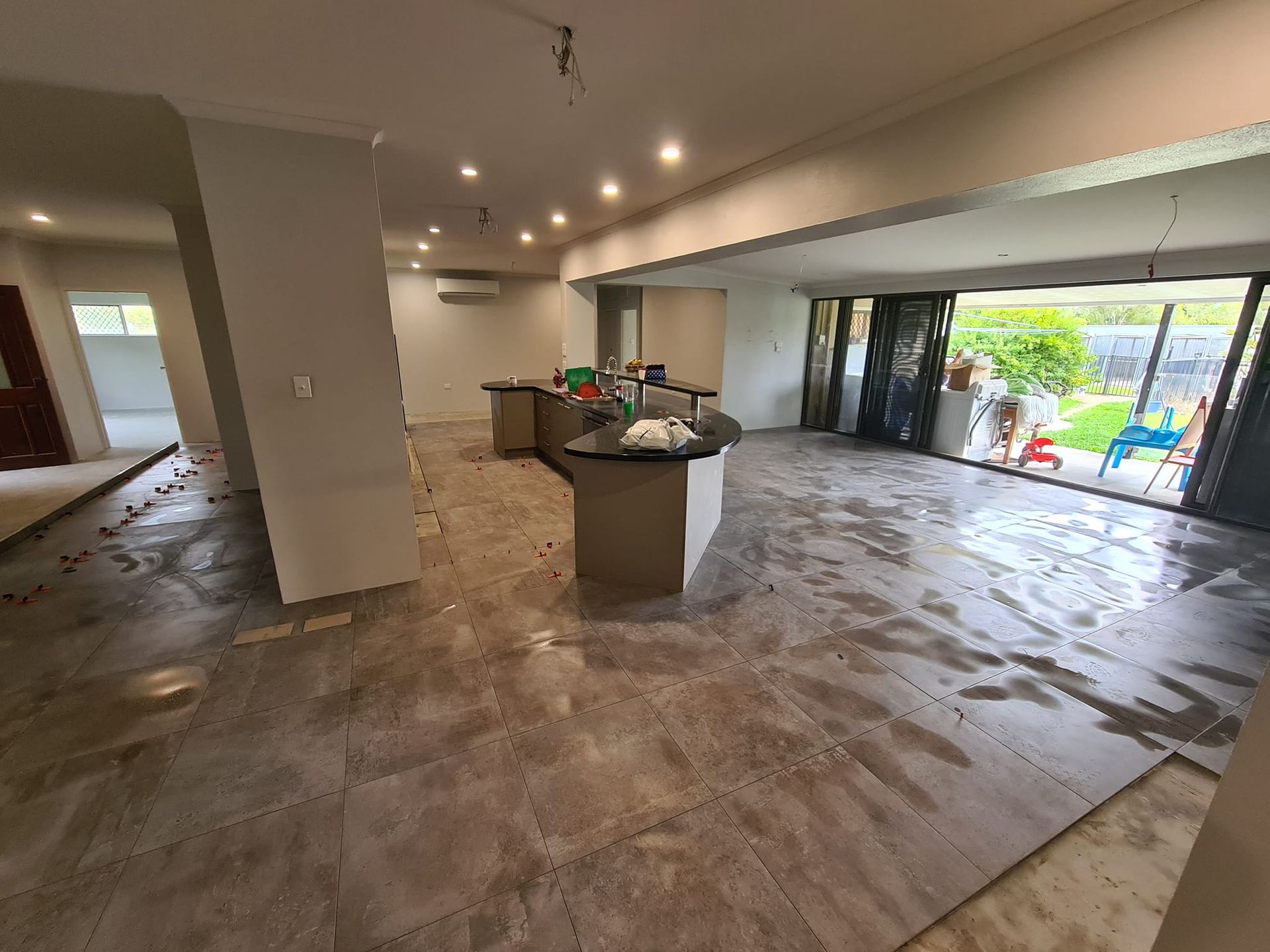 White Kitchen Under Construction With Cabinets, Ladder — Tropic Tiling in Malanda, QLD