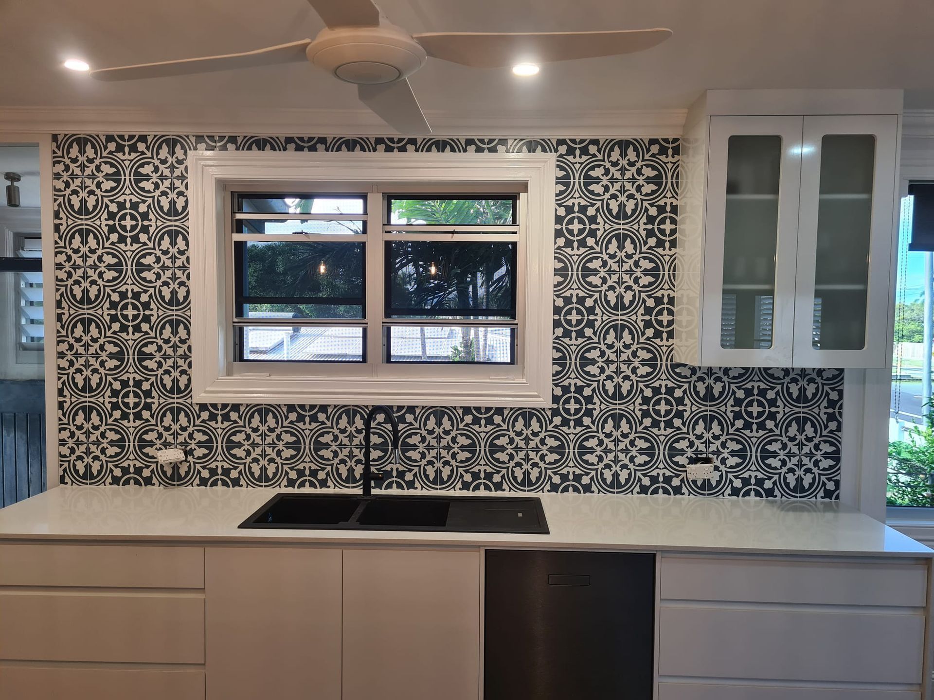 Modern bathroom with marble walls, wood vanity, and a white toilet. — Tropic Tiling in Mareeba, QLD