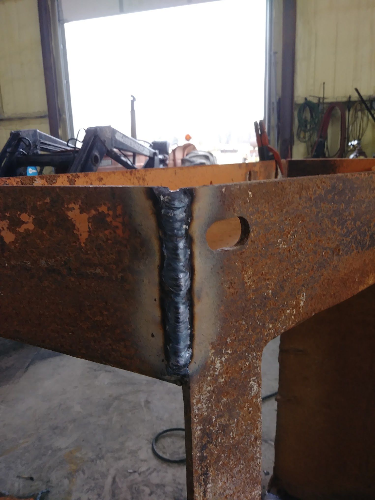 A piece of rusty metal with a hole in it