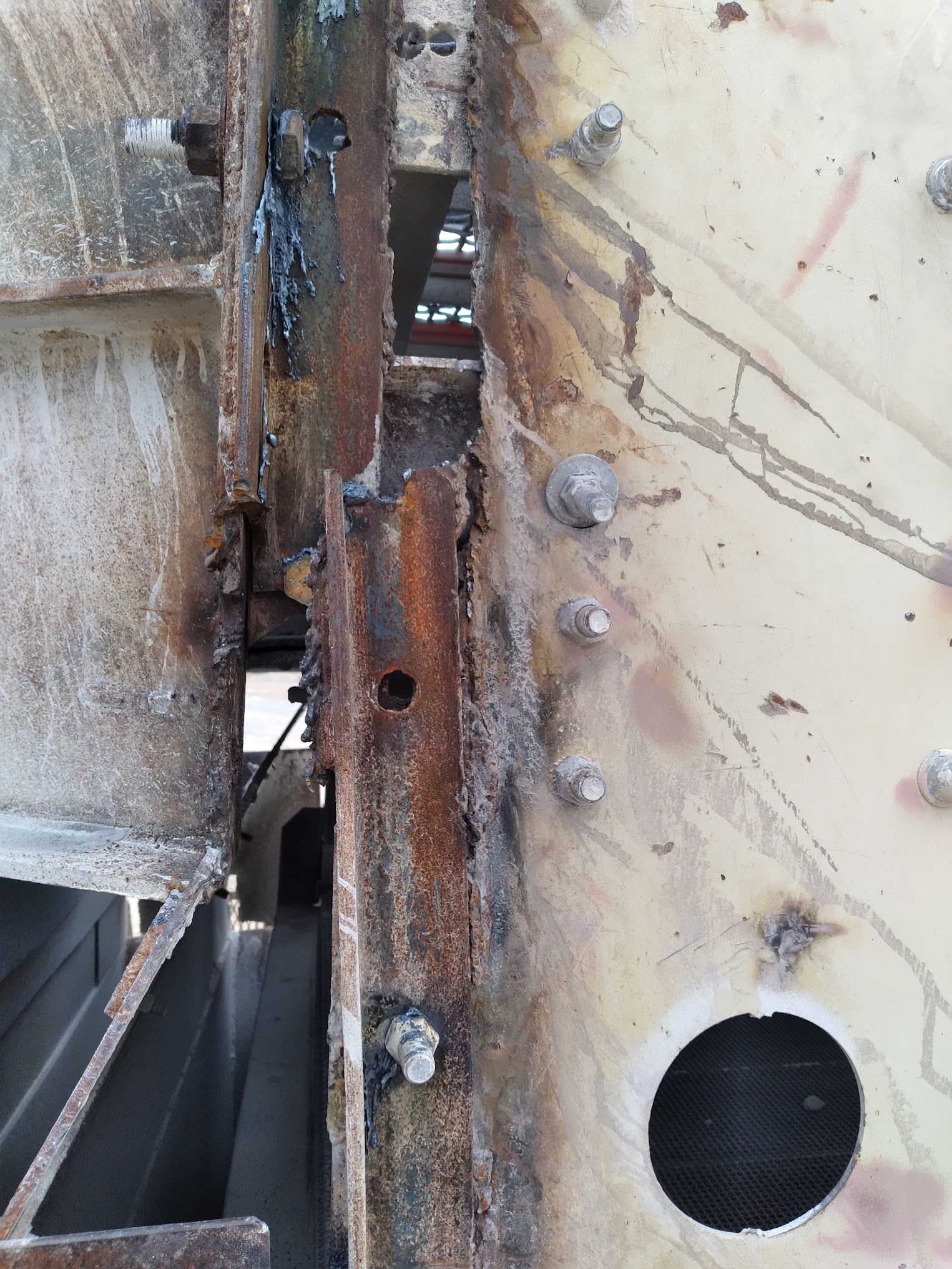 A rusty piece of metal with a hole in the middle