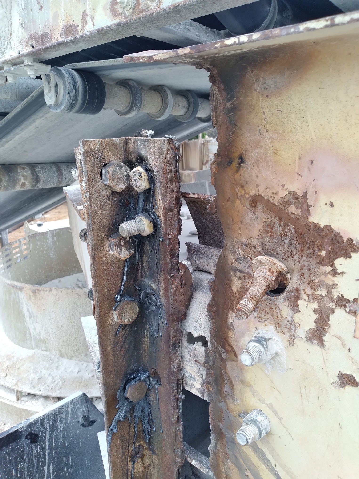 A close up of a rusty metal structure with a hole in it.