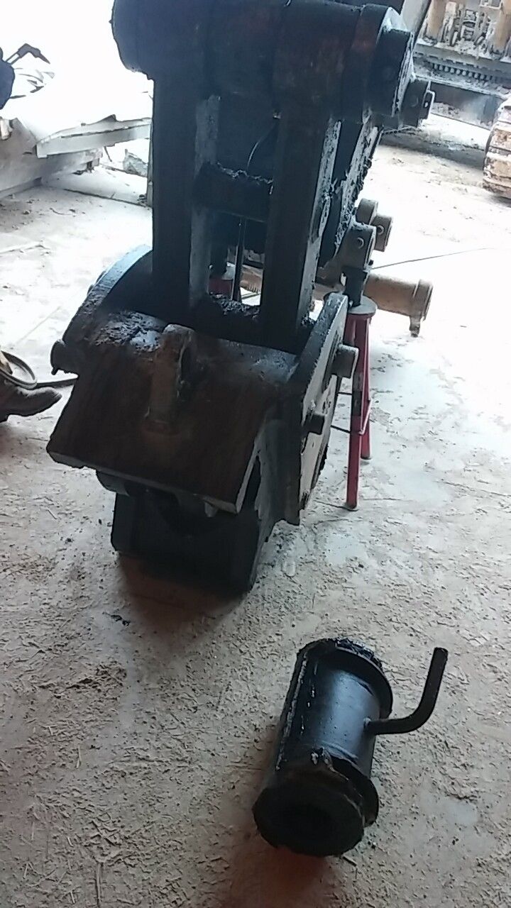 A machine is sitting on the floor next to a small object.