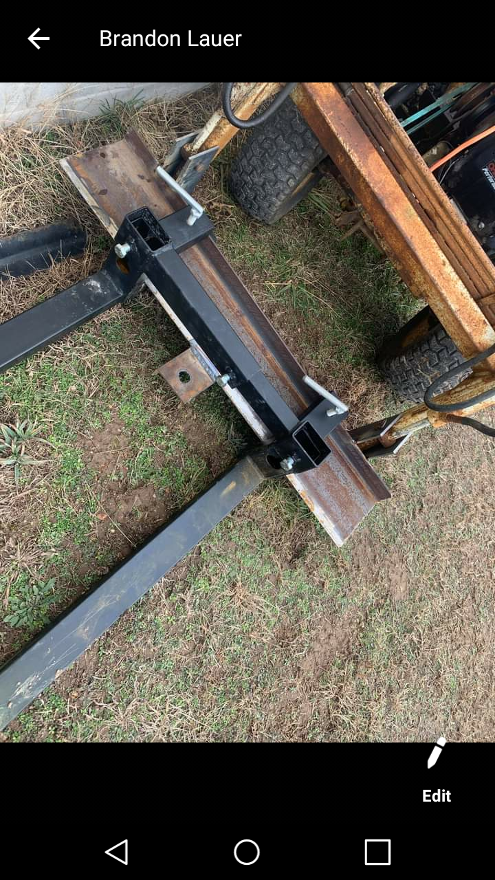 A close up of a piece of metal sitting on top of a grass covered field.