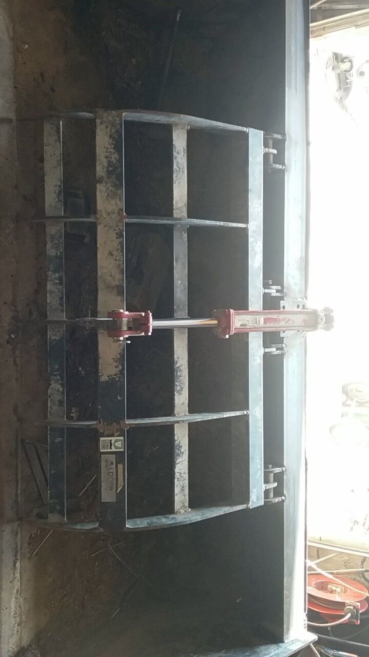 A metal object is sitting on a wall next to a window.