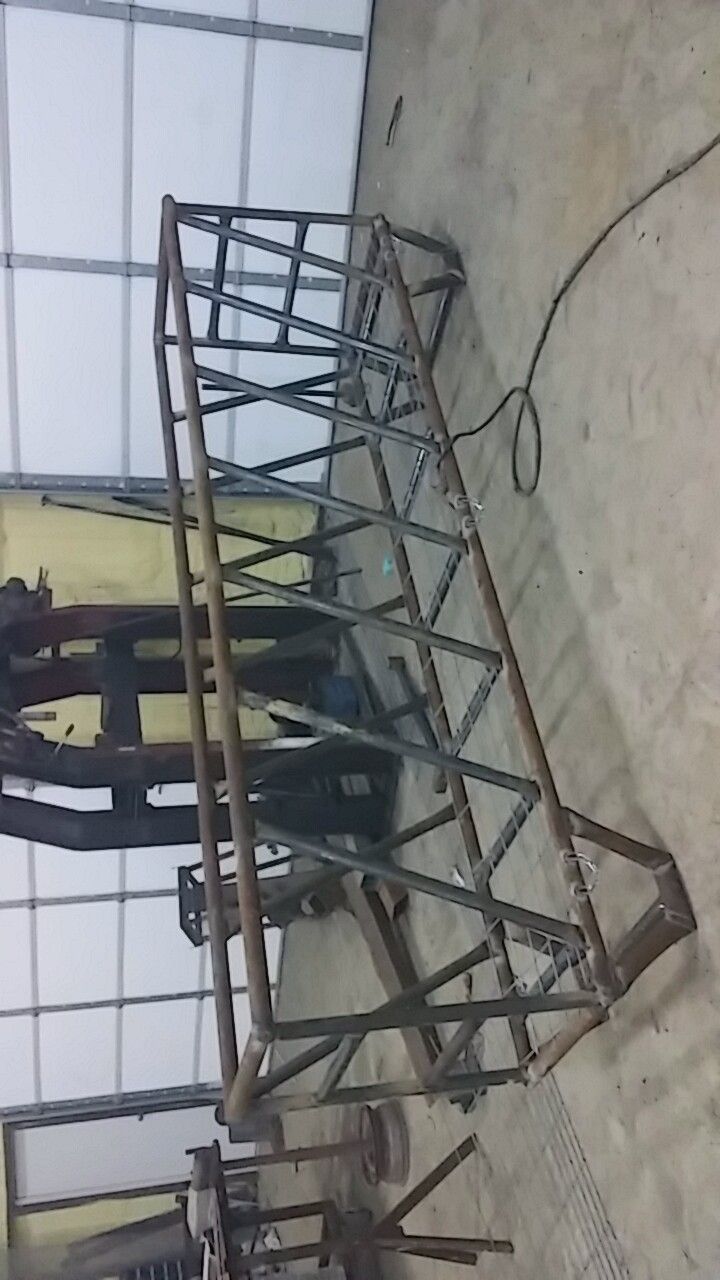 A metal structure is sitting on the ground in a room.