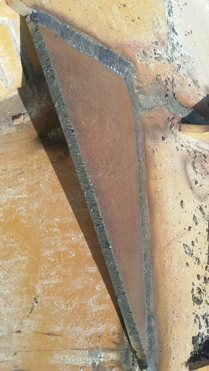 A piece of metal is sitting on top of a wooden table.