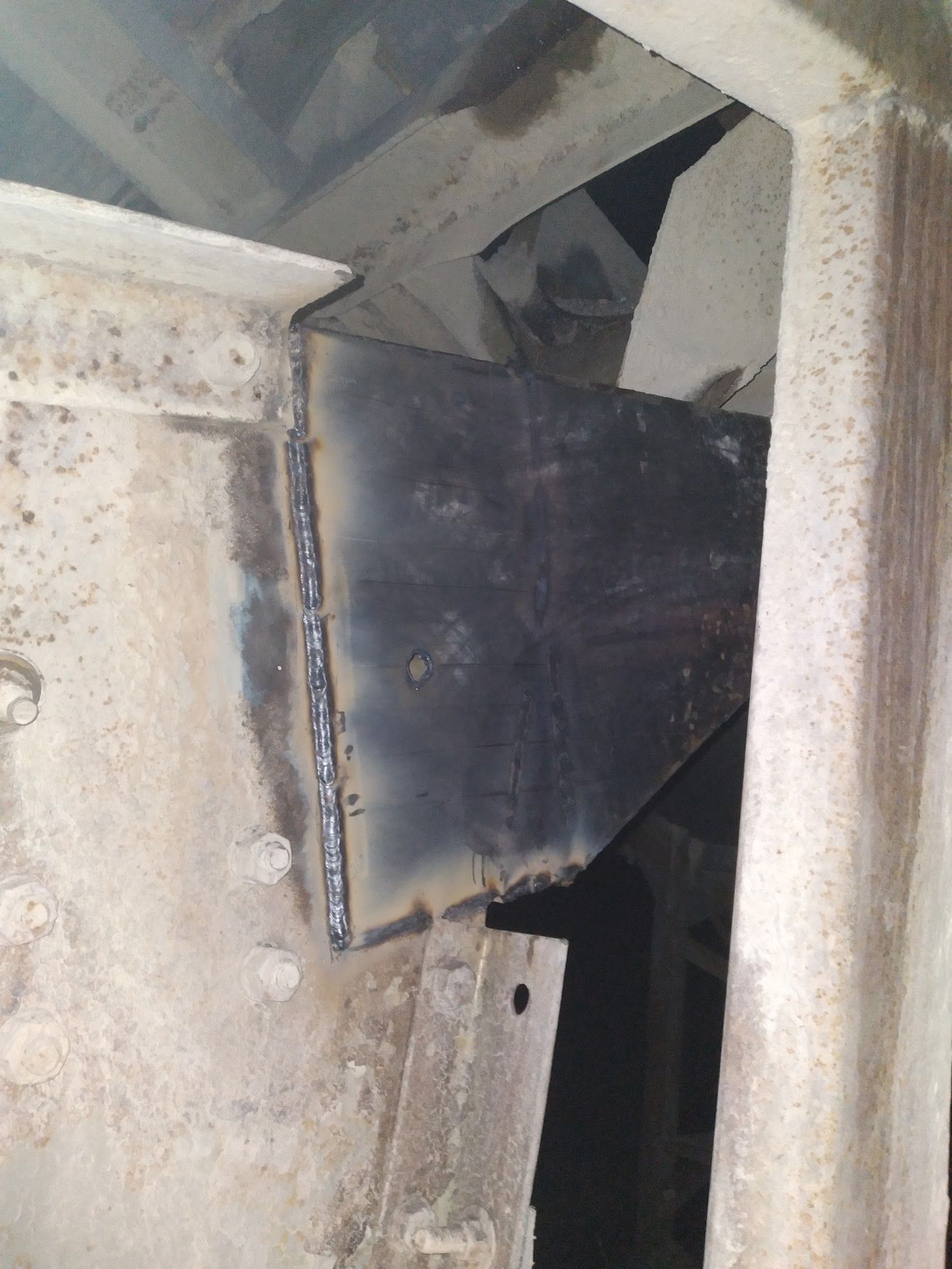 A piece of metal is sitting on top of a concrete wall.