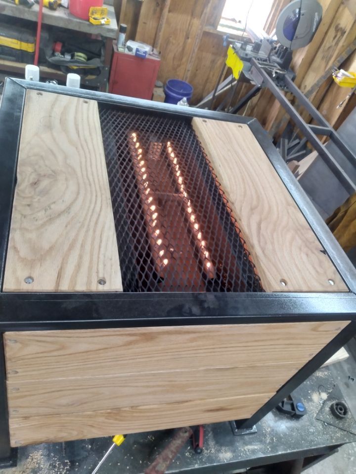 A wooden box with a metal frame is sitting on a table.