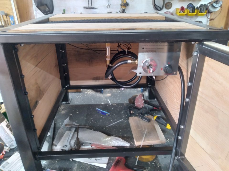 A wooden box with a metal frame is sitting on a wooden floor.