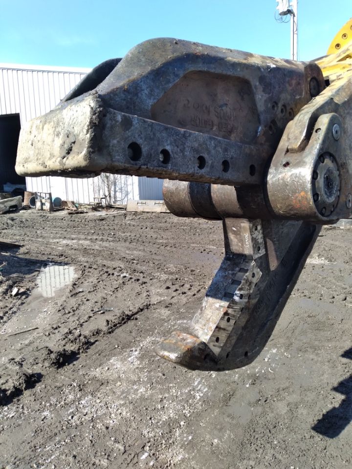 A large piece of metal is sitting on top of a dirt field.