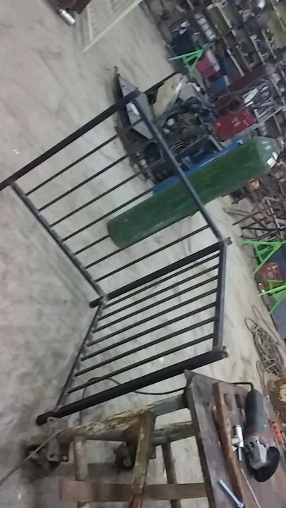 A metal railing is sitting on top of a wooden table.